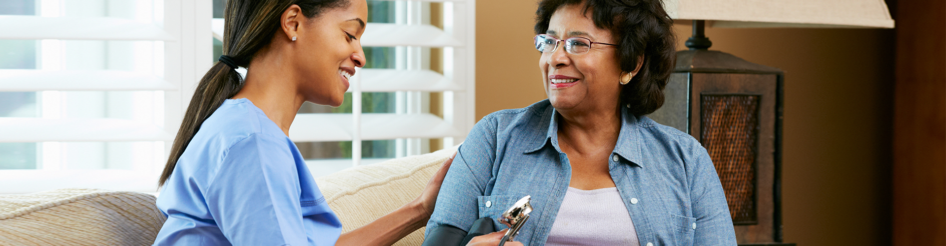 woman checking health of elderly woman